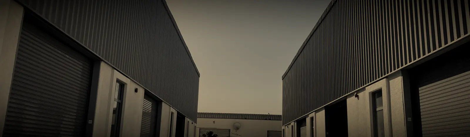 A lane between new warehouses with roller shutters in Al Quoz Industrial 4, Dubai
