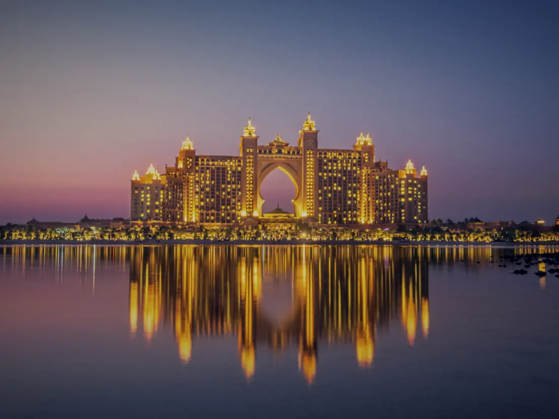 Atlantis, The Palm, lit at dusk and reflected in the water